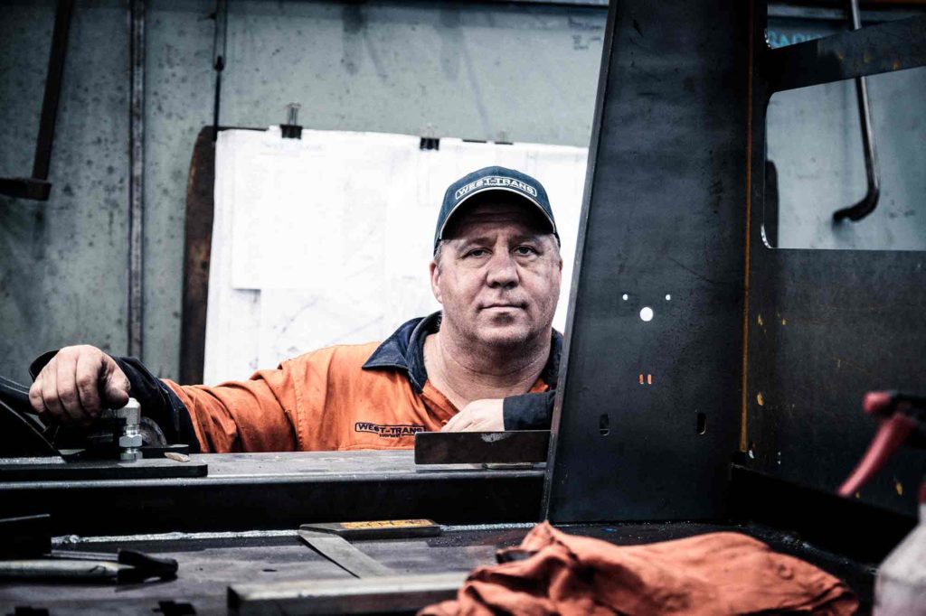 west-trans employee by his truck