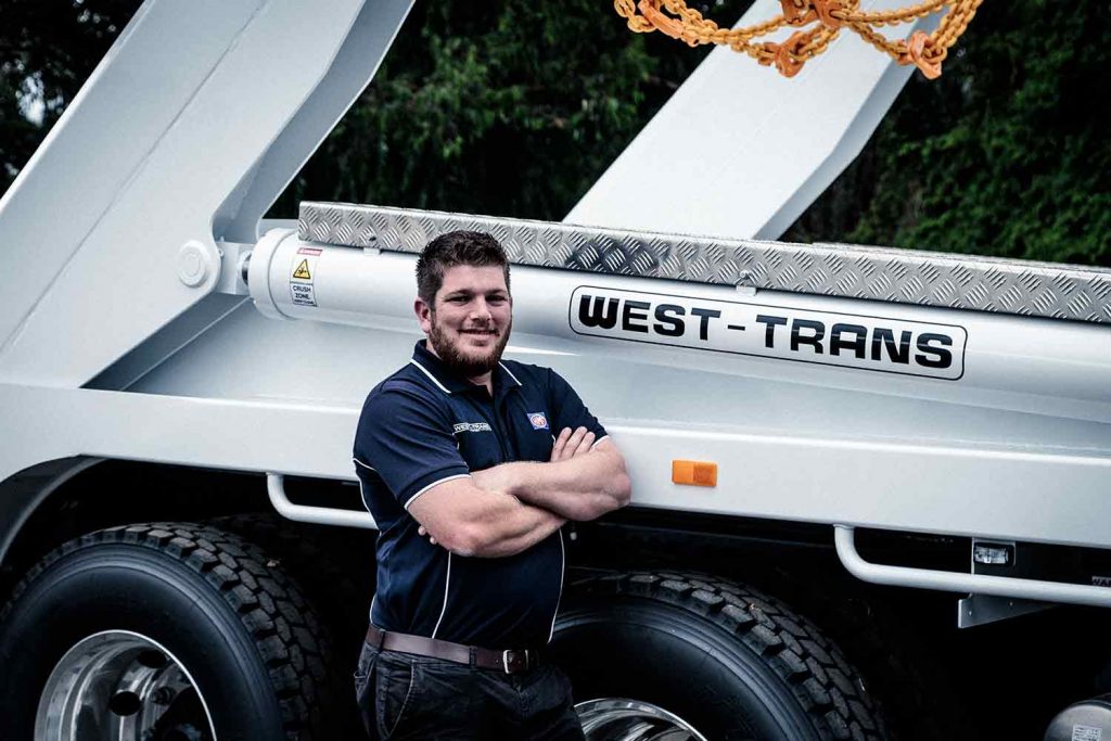 West-Trans staff leaning beside the vehicle