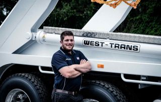 West-Trans staff leaning beside the vehicle